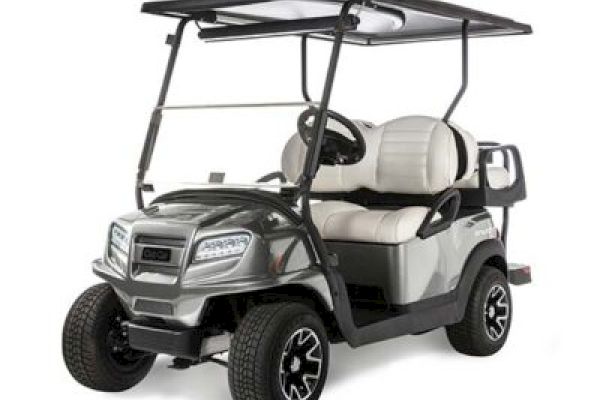 The image shows a silver golf cart with a roof, two beige seats, and black wheels, parked on a white background.